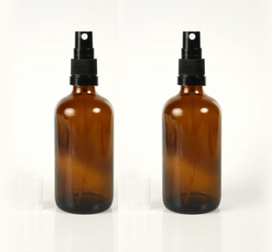 pair of amber glass travel spray bottles 50ml